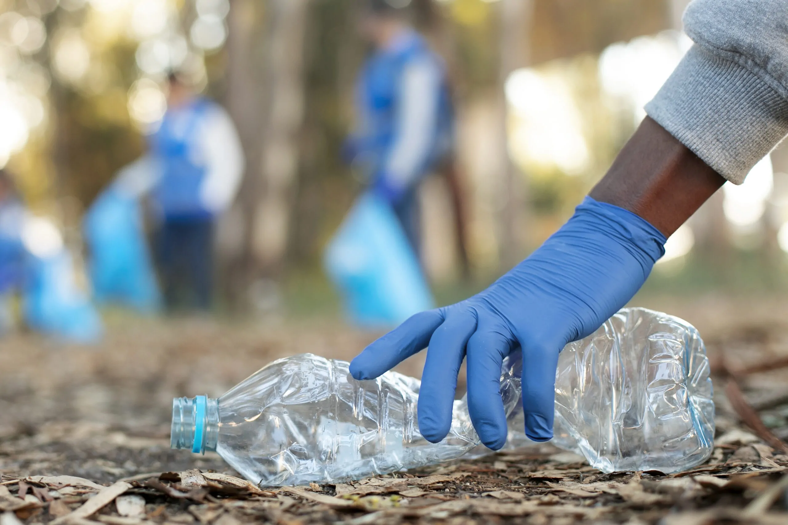 a man picking a plastic waste