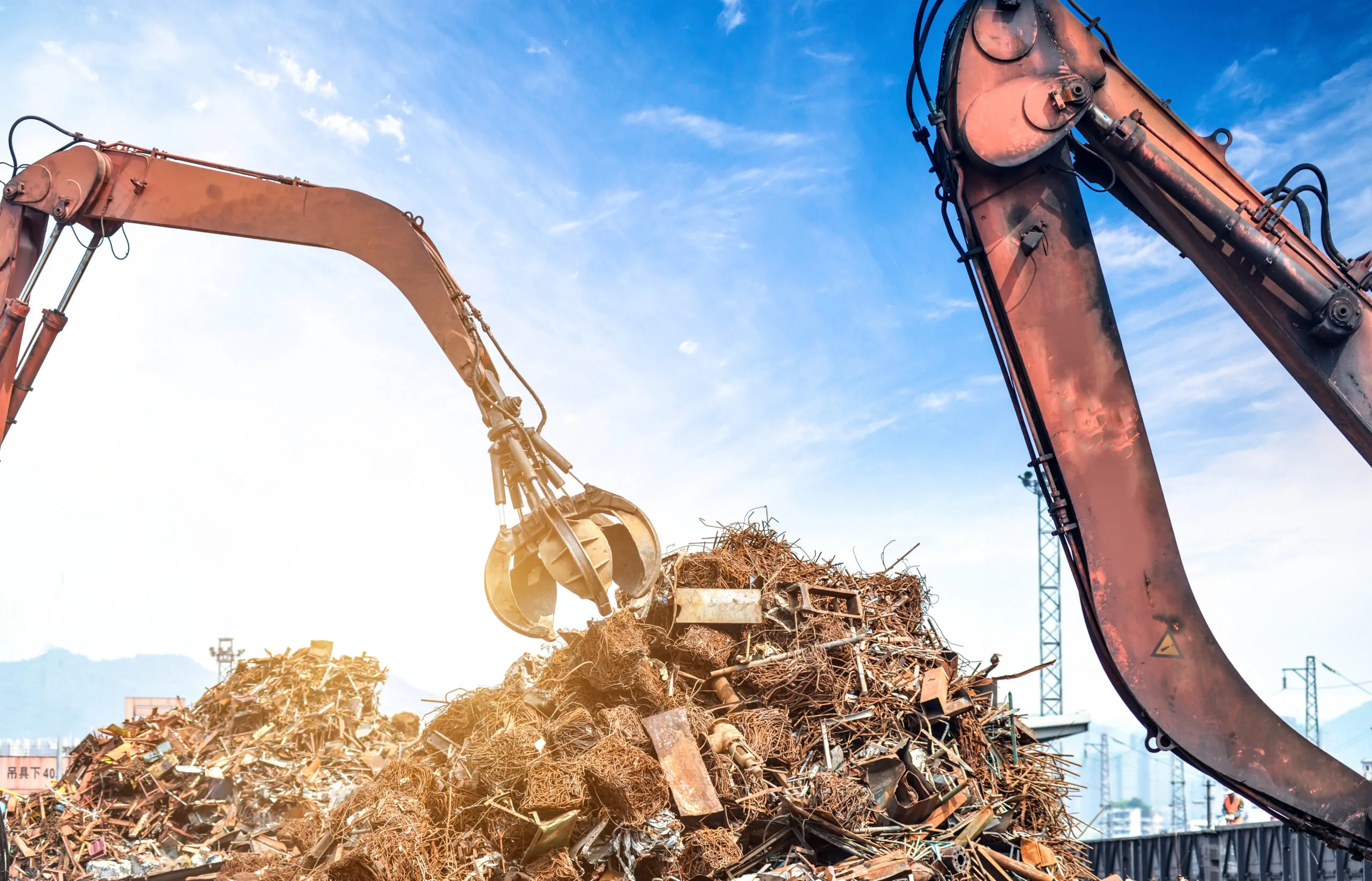 two cranes grabbing waste